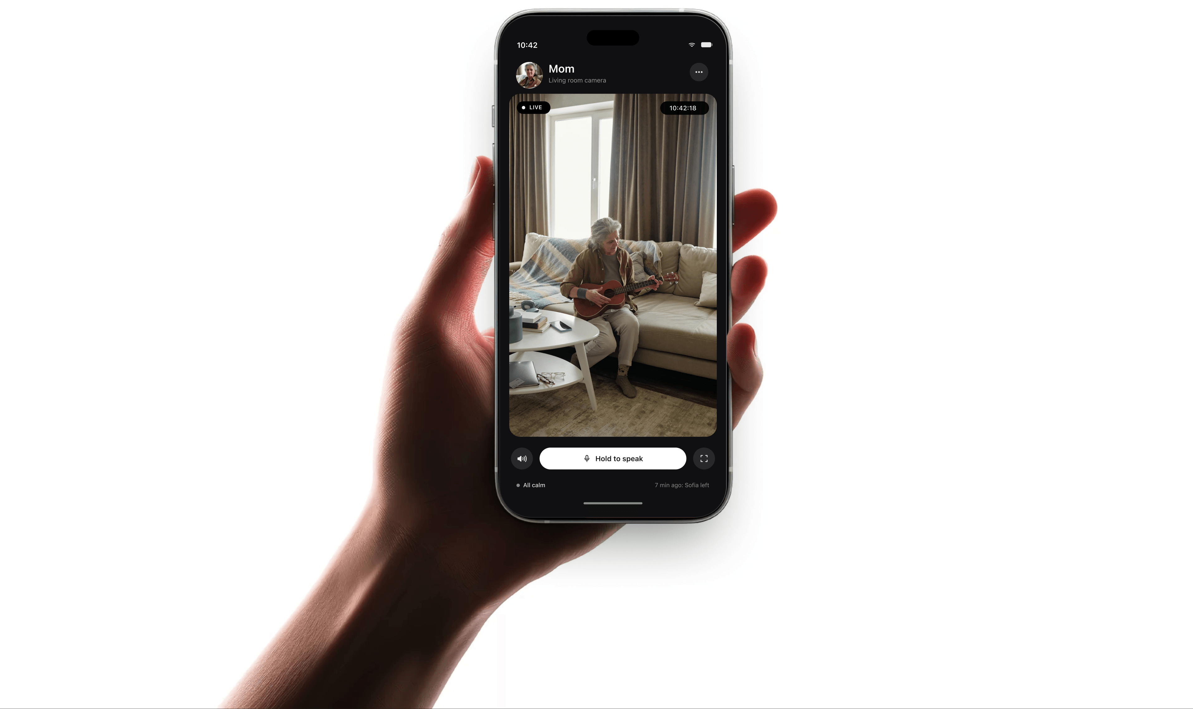 Obrigada app showing a live camera view of Mom in her living room, with a hold-to-speak control